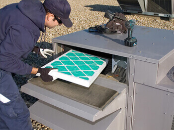 Man changing the filter of an HVAC unit