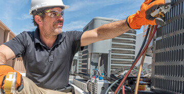 Technician servicing HVAC equipment